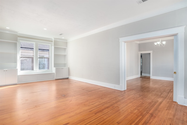 unfurnished living room featuring an inviting chandelier, light hardwood / wood-style flooring, and ornamental molding