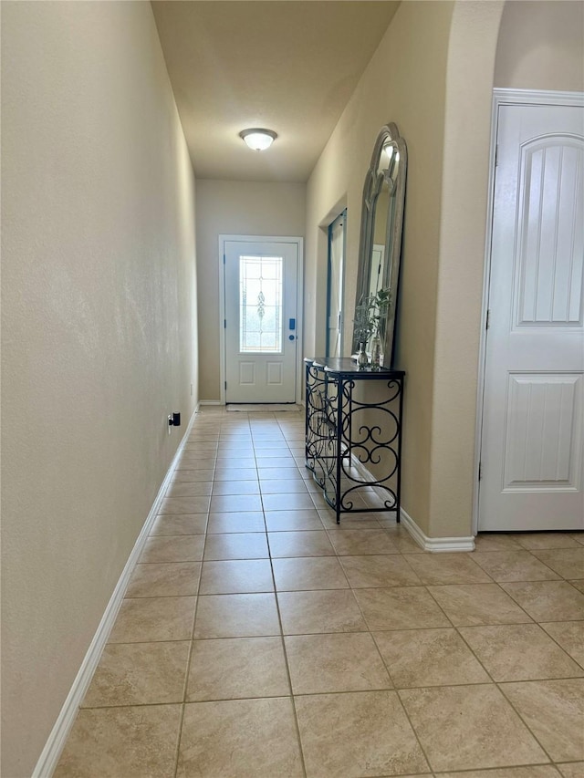 doorway to outside with light tile patterned floors