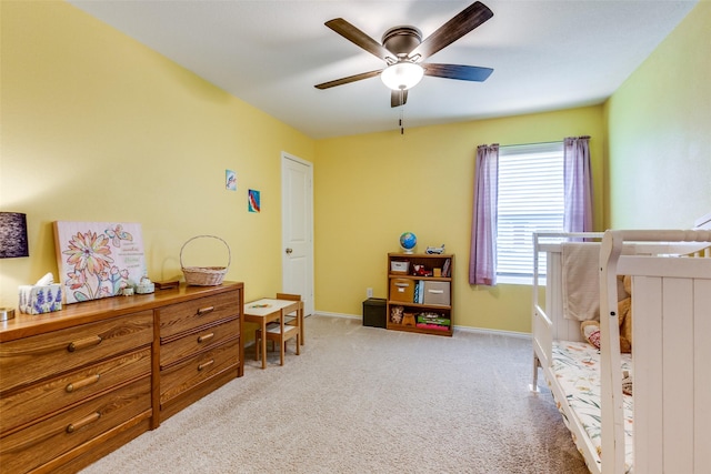 bedroom featuring light carpet and ceiling fan