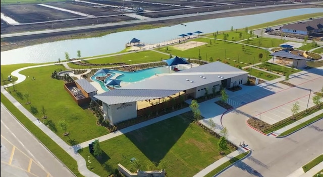 birds eye view of property with a water view