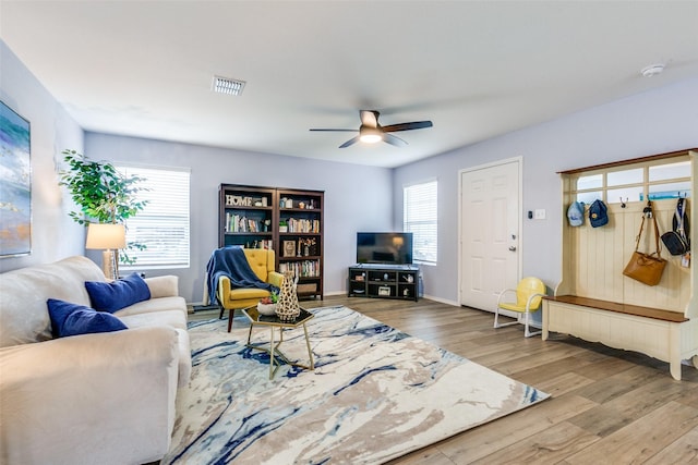 living room featuring ceiling fan and hardwood / wood-style flooring