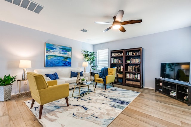 living room featuring ceiling fan and light wood-type flooring