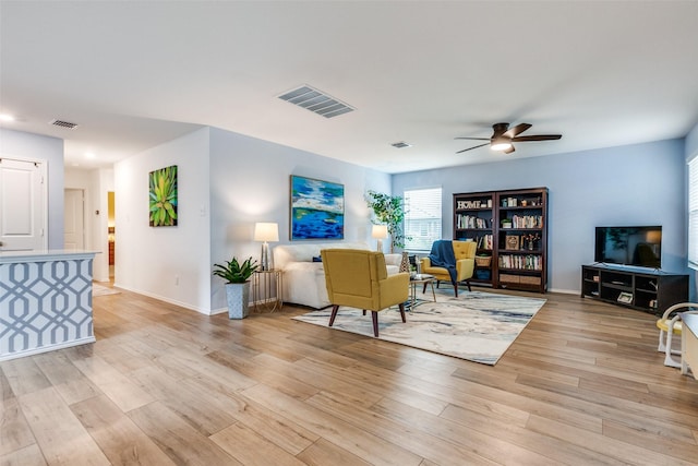 living room featuring ceiling fan and light wood-type flooring