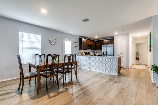 dining room with light wood-type flooring