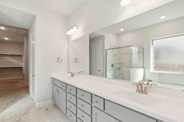 bathroom with vanity and a shower with door