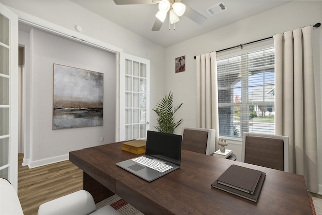 home office with wood-type flooring and ceiling fan