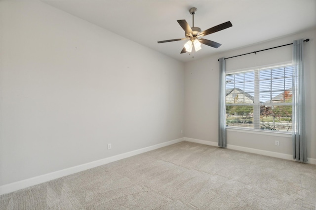 empty room featuring light colored carpet and ceiling fan