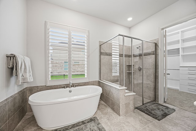 bathroom with tile patterned floors and plus walk in shower