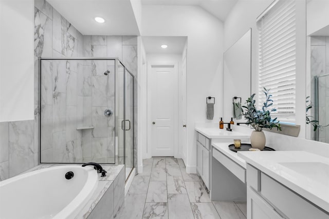 bathroom with vanity and shower with separate bathtub