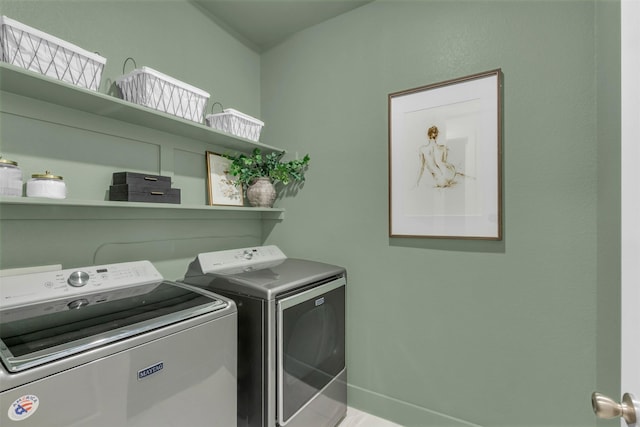 clothes washing area featuring separate washer and dryer