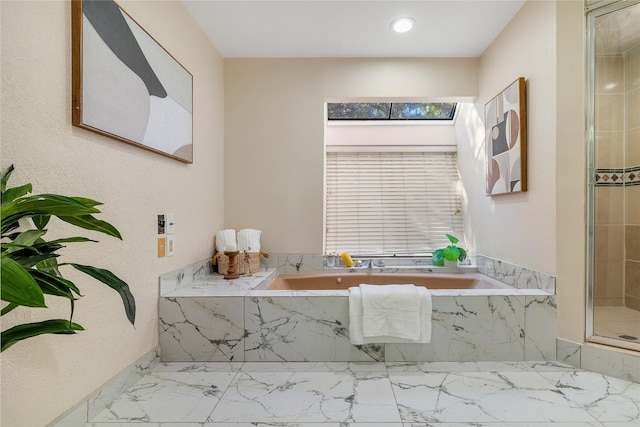 bathroom featuring shower with separate bathtub