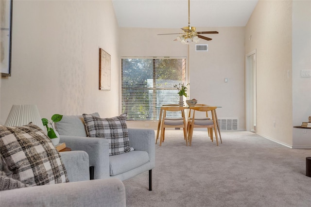 living area featuring light colored carpet, high vaulted ceiling, and ceiling fan