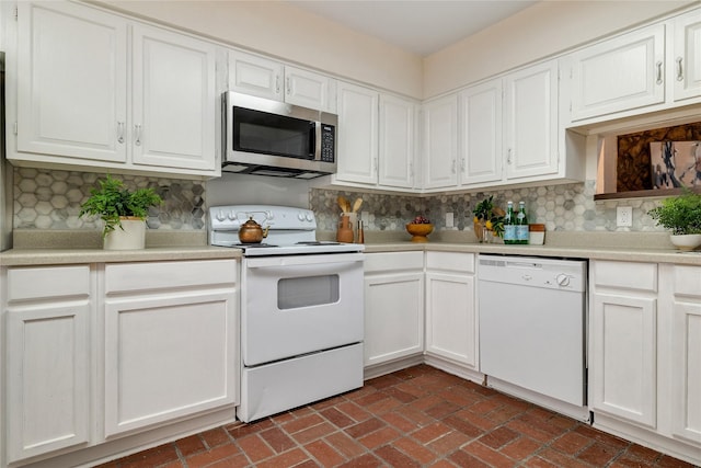 kitchen featuring tasteful backsplash, white cabinetry, and white appliances