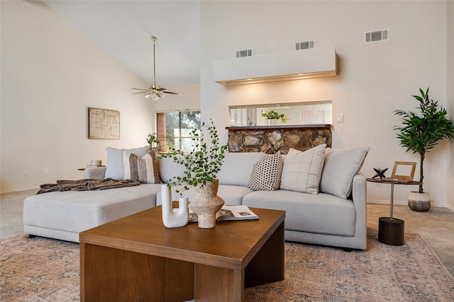 living room featuring high vaulted ceiling, ceiling fan, and carpet flooring