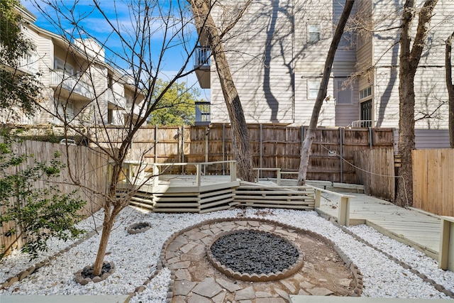 view of patio featuring a fire pit and a deck