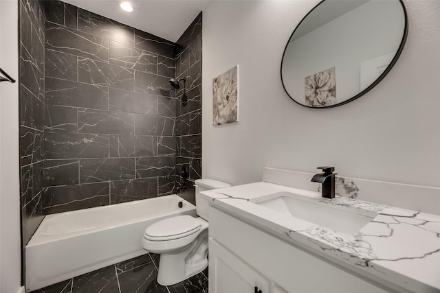 full bathroom featuring tiled shower / bath combo, vanity, and toilet