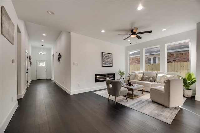 living room with ceiling fan and dark hardwood / wood-style floors