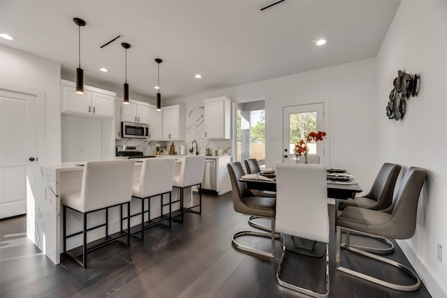 dining area featuring dark hardwood / wood-style flooring and sink