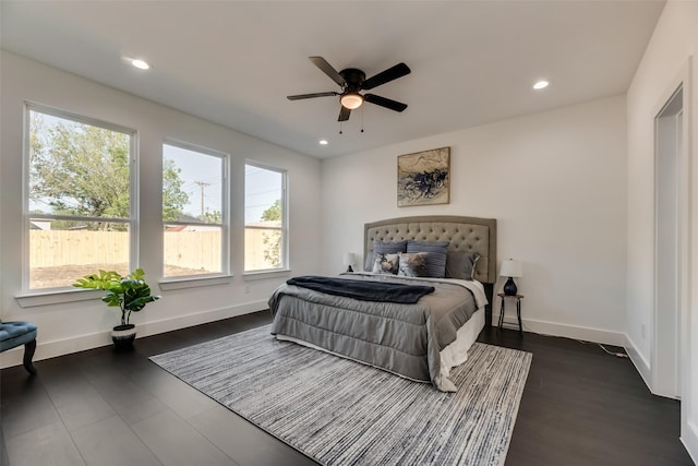 bedroom with ceiling fan and dark hardwood / wood-style flooring