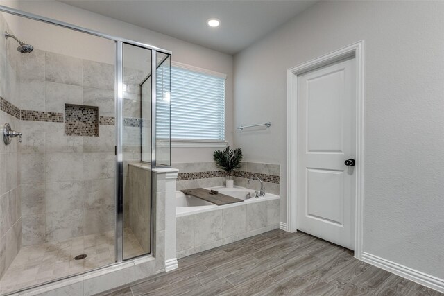 bathroom with wood-type flooring and separate shower and tub