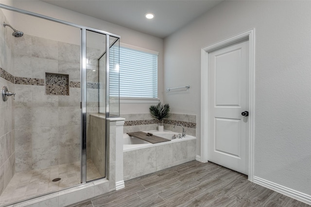 bathroom with wood-type flooring and plus walk in shower