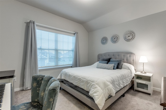 carpeted bedroom featuring lofted ceiling and multiple windows