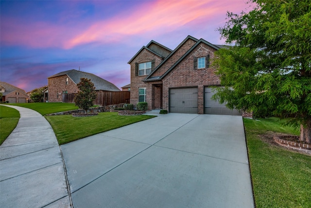 view of front of property with a lawn and a garage