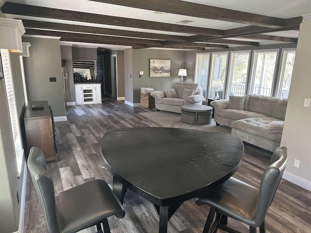 living room featuring dark hardwood / wood-style flooring and beam ceiling