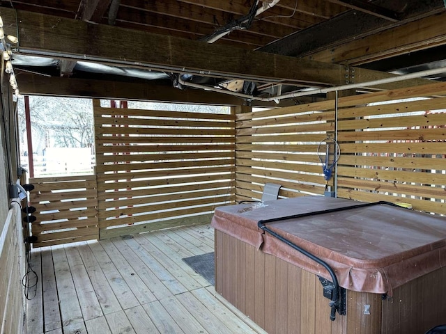 wooden deck featuring a hot tub