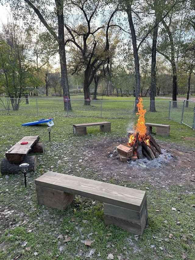 surrounding community featuring an outdoor fire pit