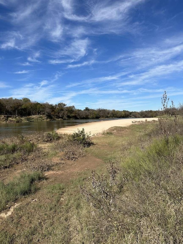 view of landscape with a rural view and a water view