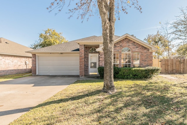 single story home featuring a garage and a front yard