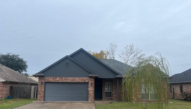 view of front of house featuring a front lawn and a garage