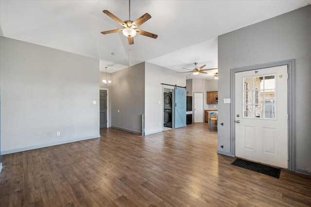 unfurnished living room featuring a barn door, ceiling fan, dark hardwood / wood-style floors, and lofted ceiling