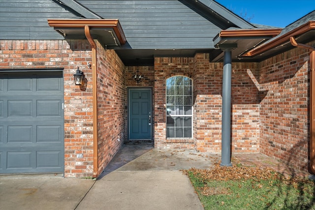 view of exterior entry with a garage