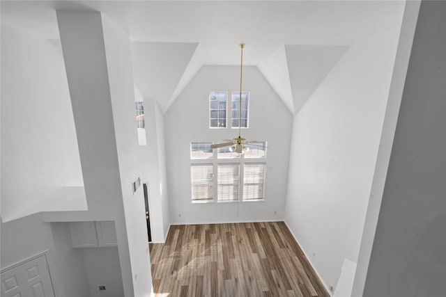 interior space with ceiling fan, high vaulted ceiling, and wood-type flooring