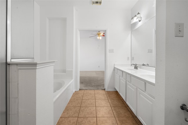 bathroom with a tub to relax in, ceiling fan, tile patterned flooring, and vanity