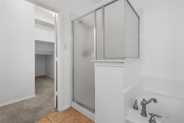 bathroom featuring tile patterned flooring and plus walk in shower