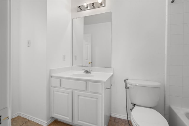 bathroom featuring tile patterned flooring, vanity, and toilet