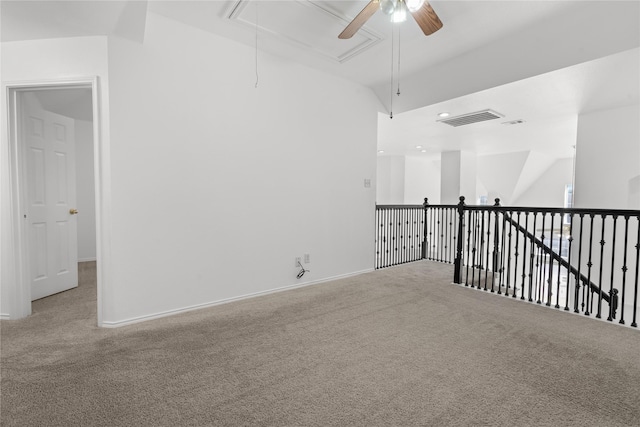 empty room featuring ceiling fan and carpet