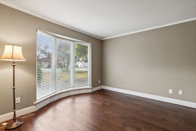 empty room with dark hardwood / wood-style floors and ornamental molding