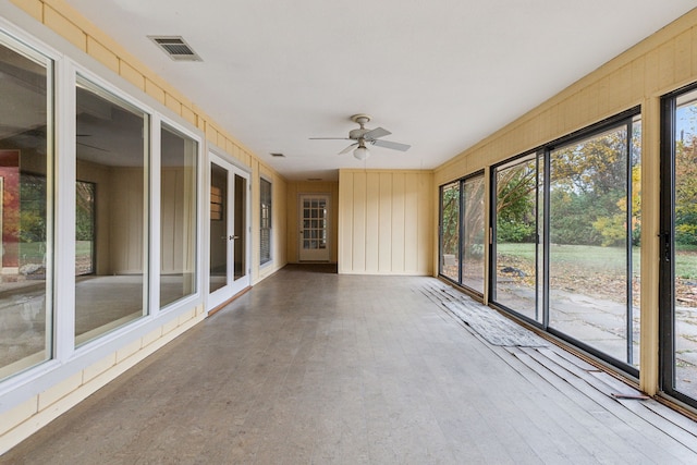 unfurnished sunroom with ceiling fan