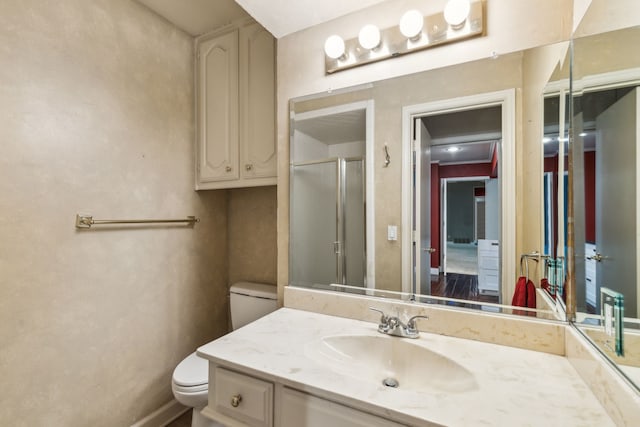 bathroom featuring vanity, toilet, and an enclosed shower