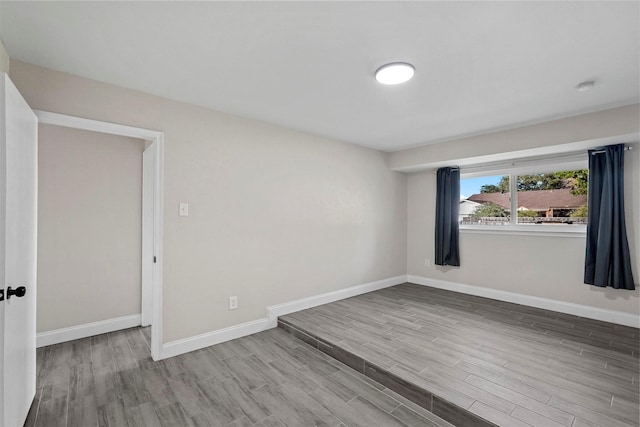 unfurnished room featuring hardwood / wood-style flooring