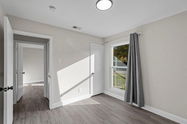 empty room featuring wood-type flooring