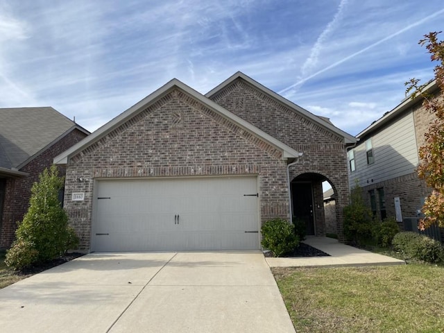 view of front of property with a garage and a front yard