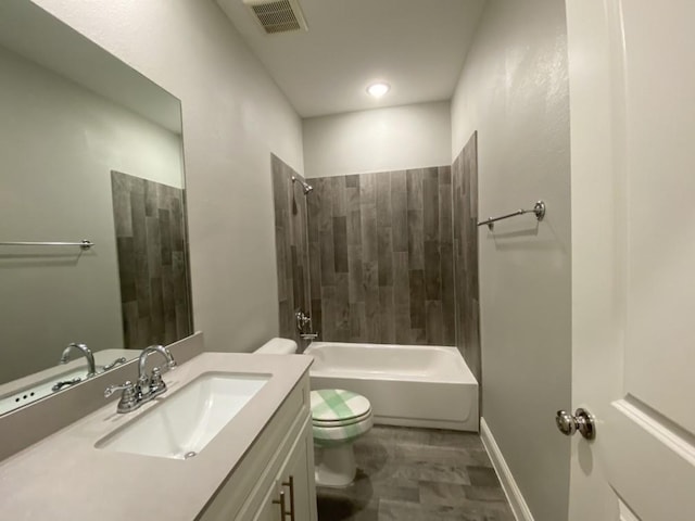 full bathroom with tiled shower / bath combo, toilet, and vanity