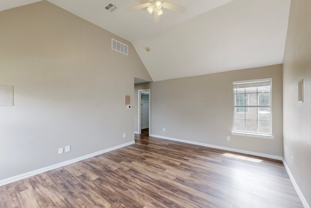 empty room featuring ceiling fan, dark wood-type flooring, and high vaulted ceiling