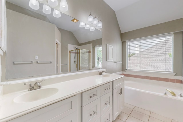 bathroom with tile patterned floors, vanity, shower with separate bathtub, and vaulted ceiling