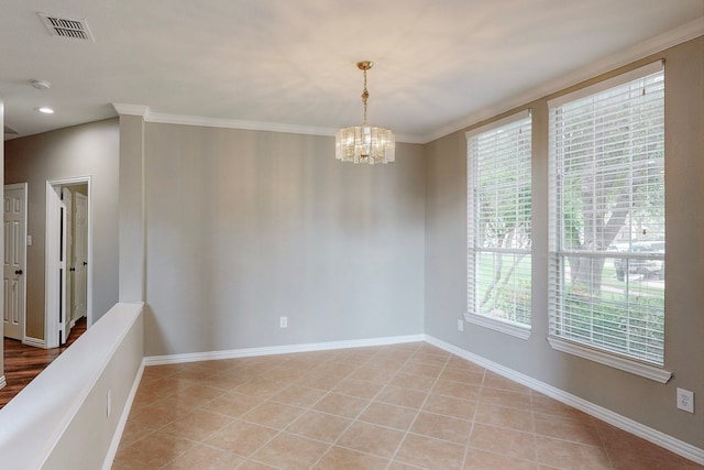 tiled empty room featuring crown molding, a wealth of natural light, and a notable chandelier